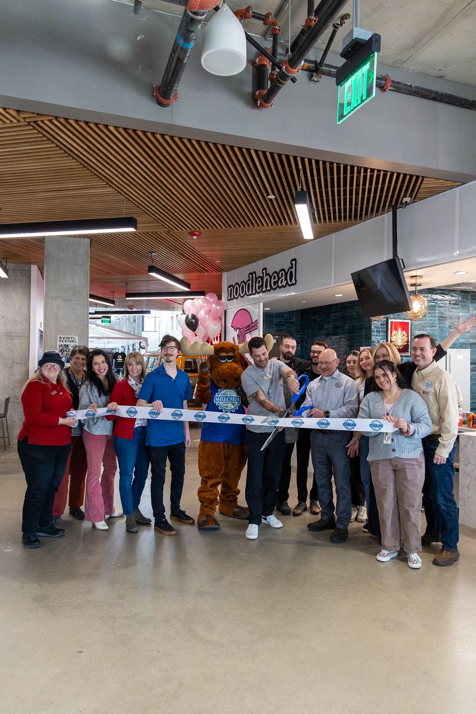 The ribbon cutting at Millcreek Common with the Millcreek moose mascot